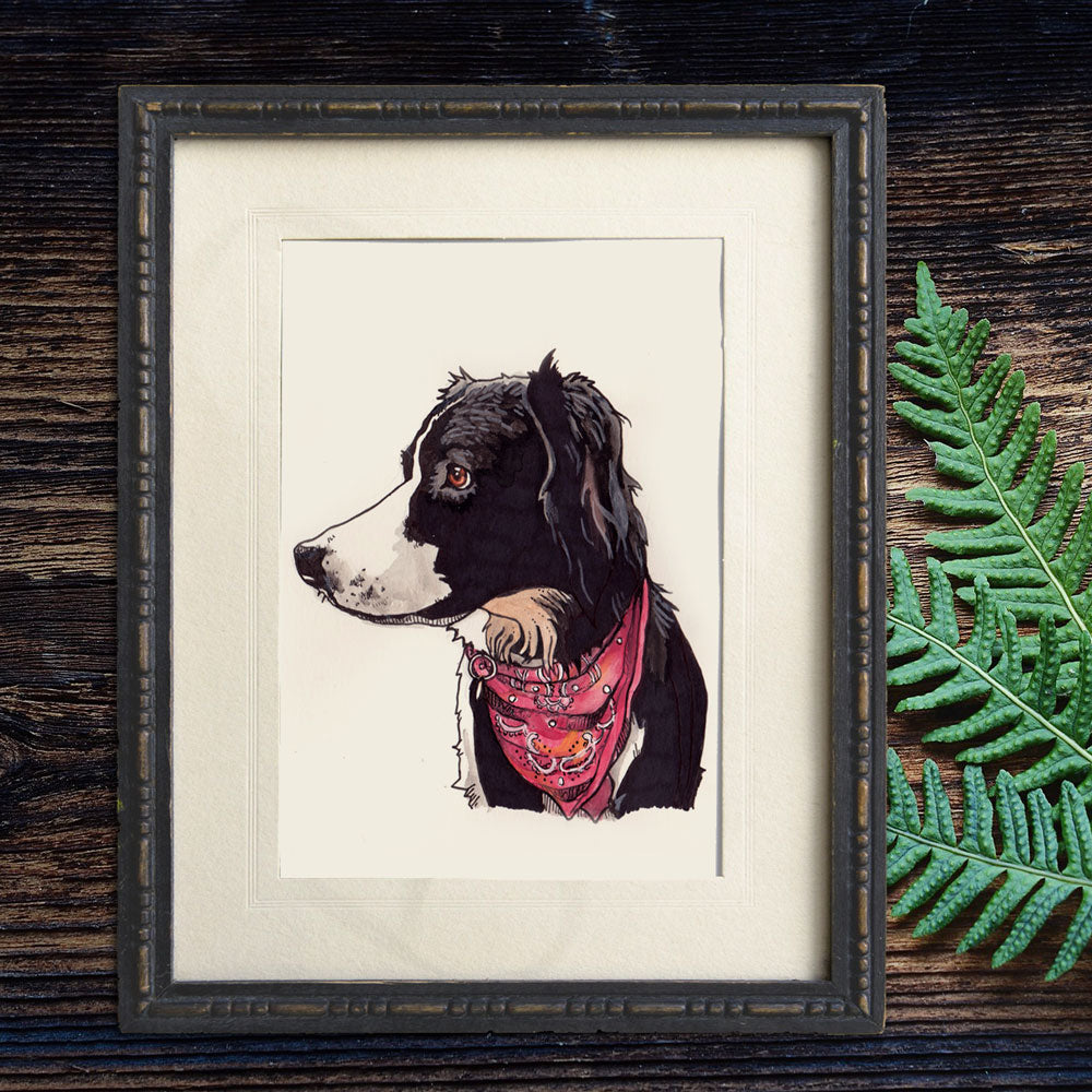 Framed illustration of a dog wearing a bandana on a wooden surface with a fern leaf.